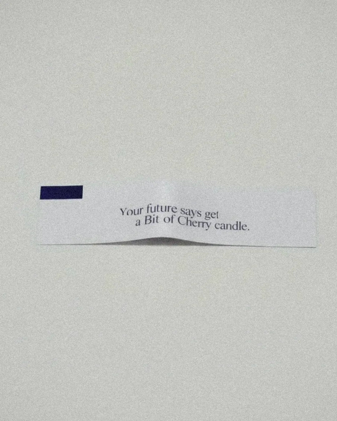 Bit of Cherry Fortune cookie with text on a plain background